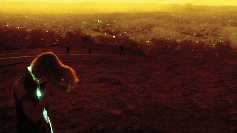 person on hill at sunset