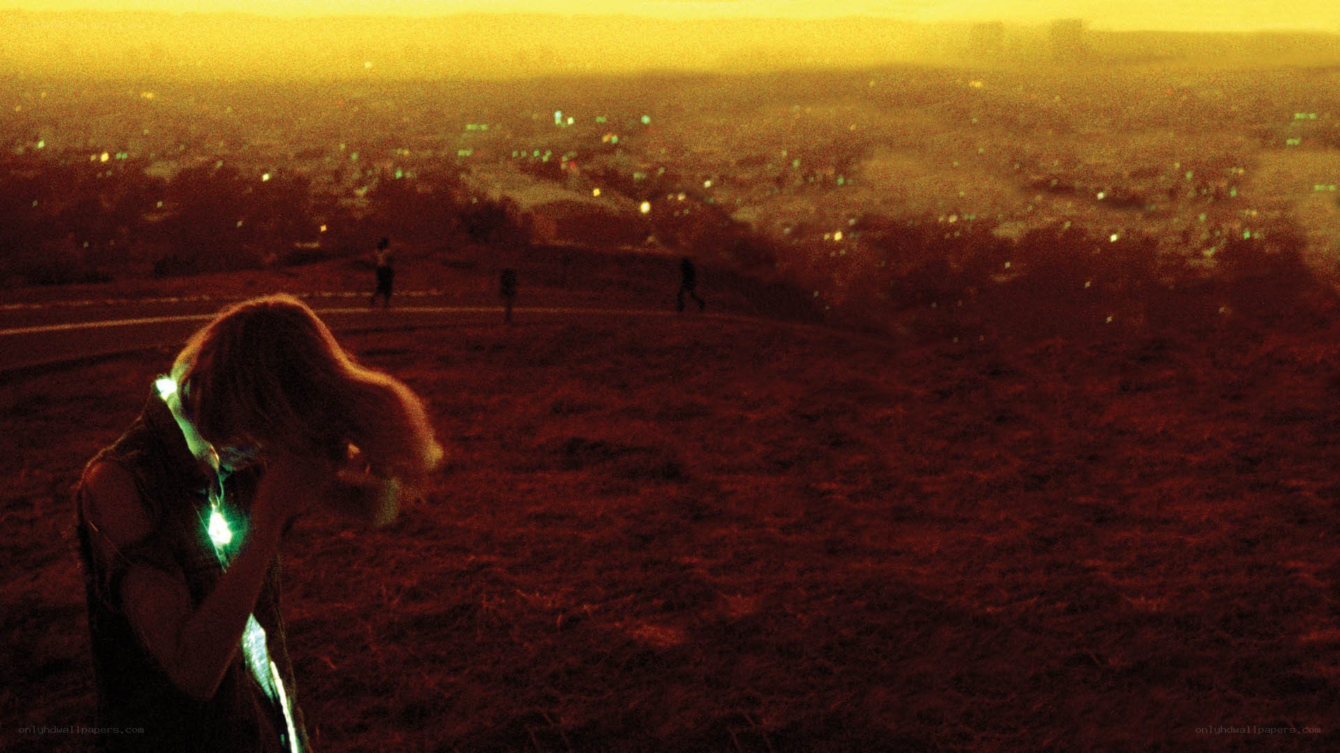 person on hill at sunset
