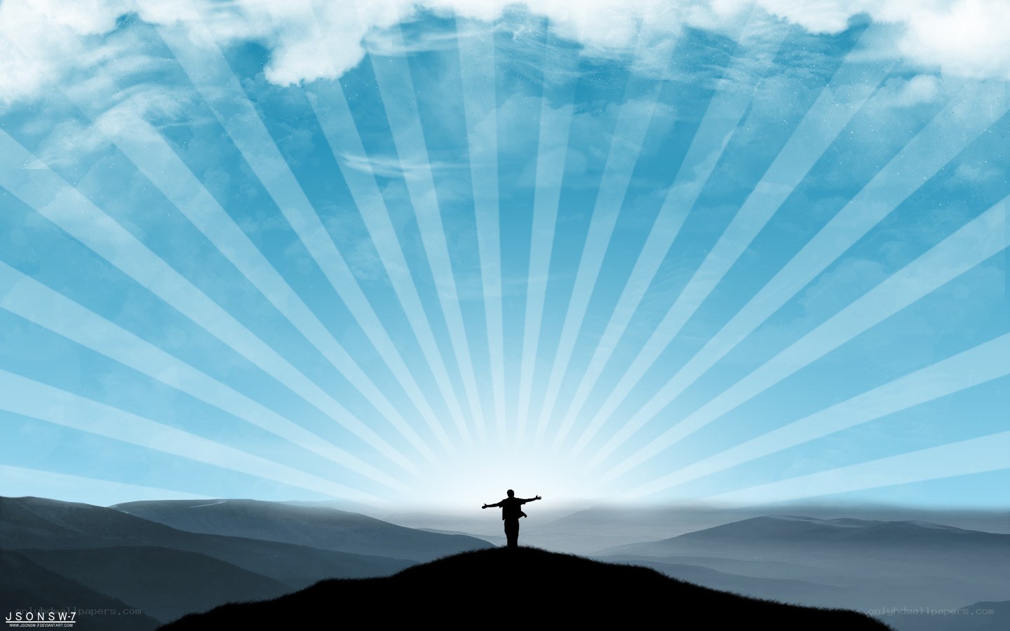 person on hill with sun rays