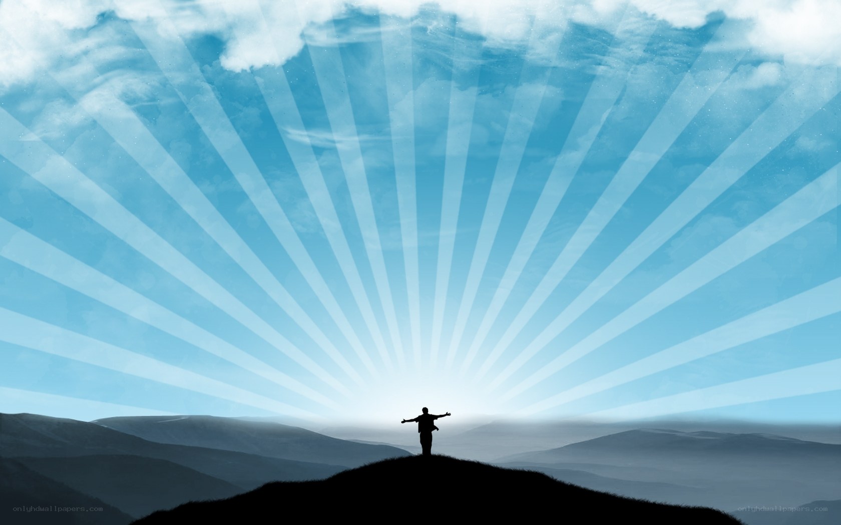 person on hill with sun rays