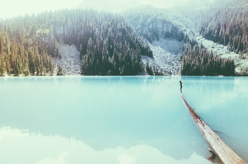 Person on Log in Lake