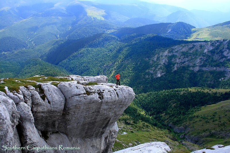 Person on Mountain Cliff