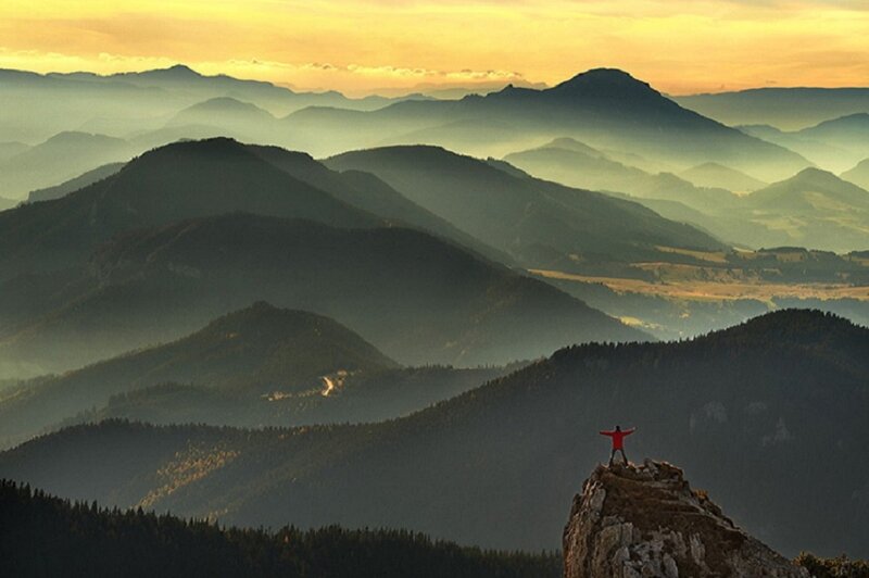 Person on Mountain Peak — Yellow