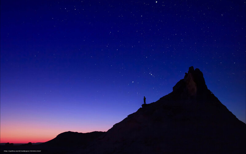 Person on mountain under stars