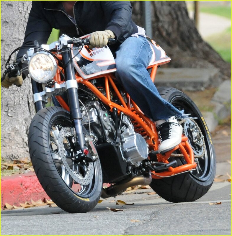 Person on Orange Motorcycle