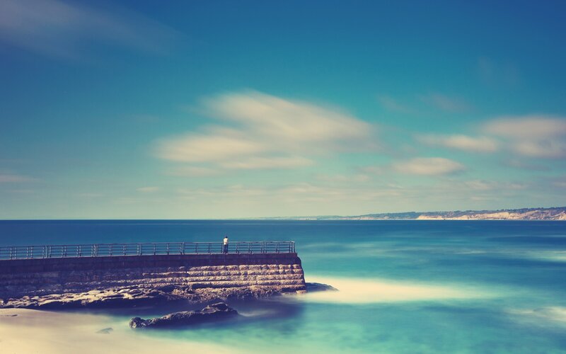 Person on Pier at Ocean — Blue