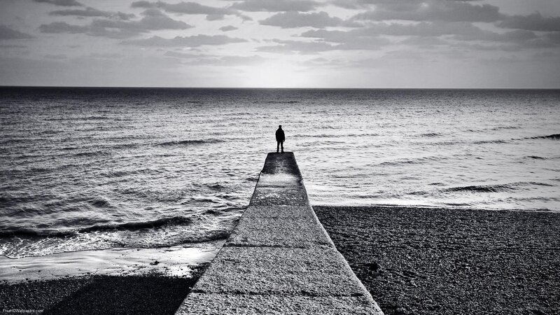person on pier at sea