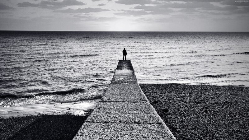 person on pier at sea