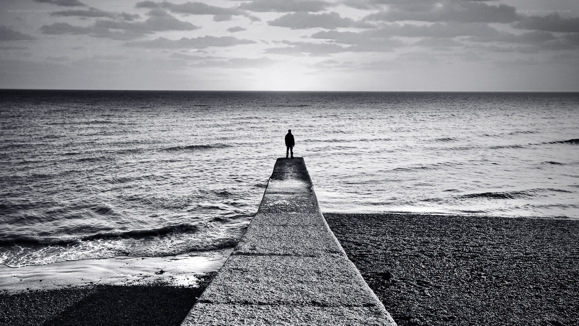person on pier at sea
