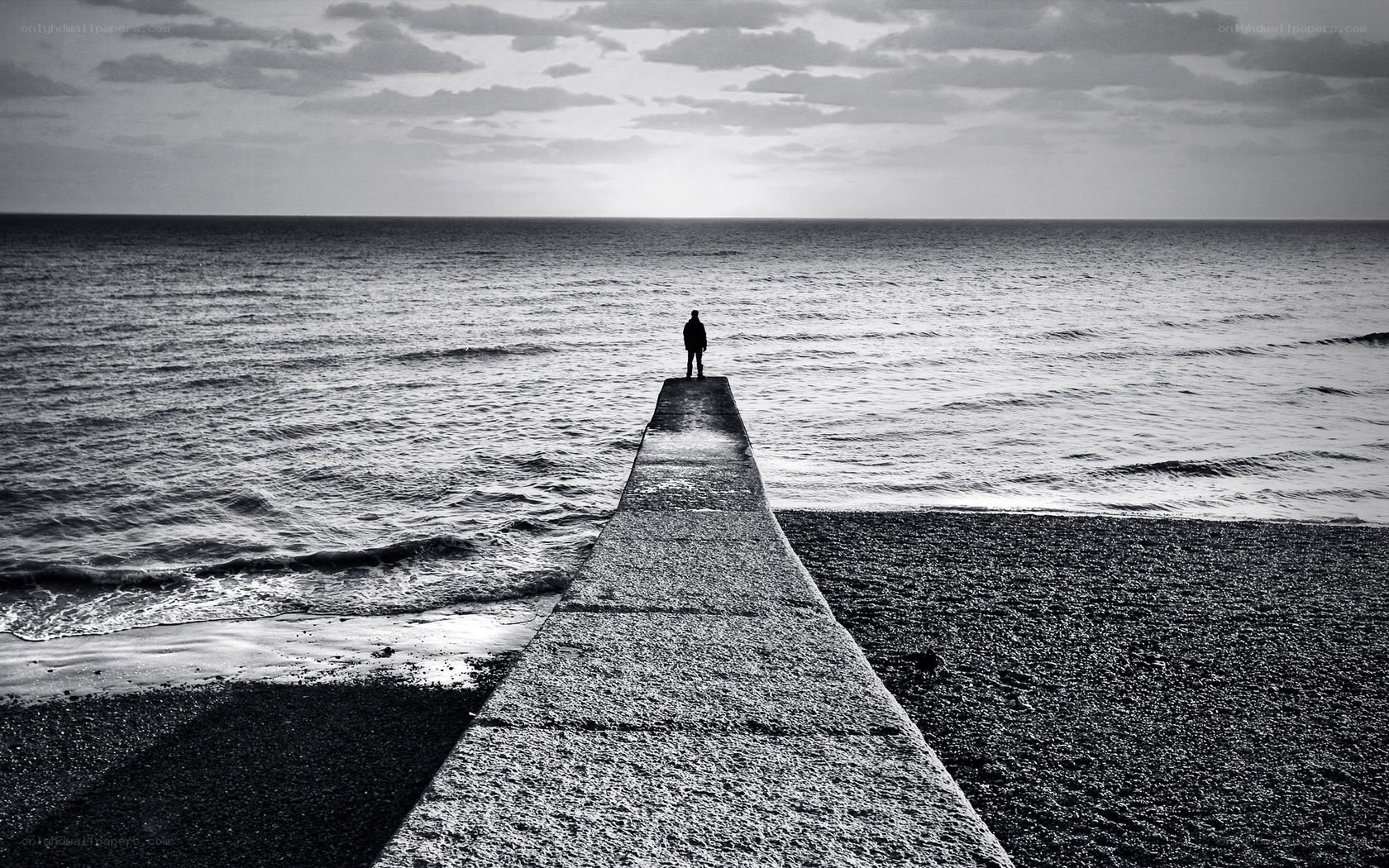 Person on pier at sea