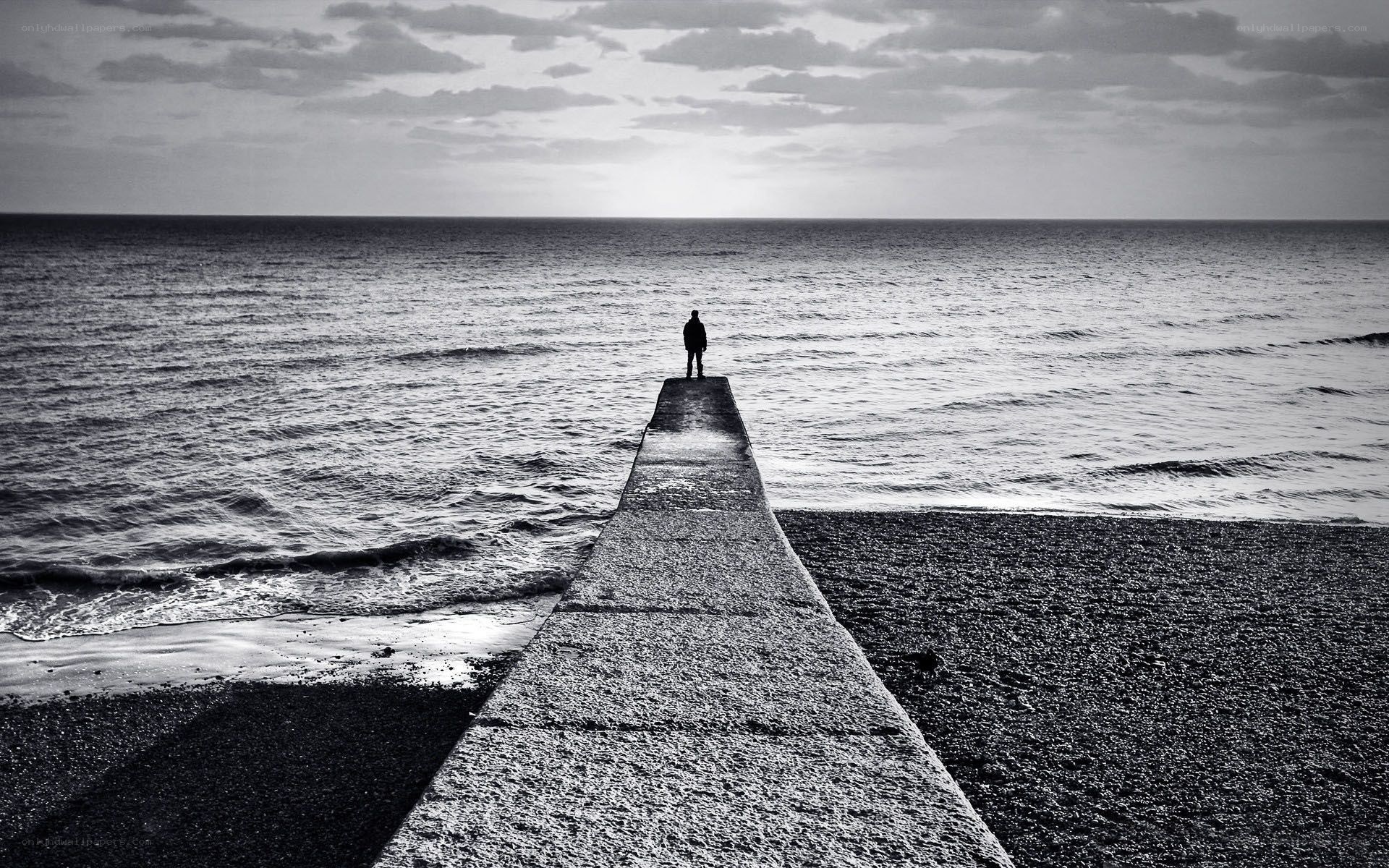 Person on pier at sea