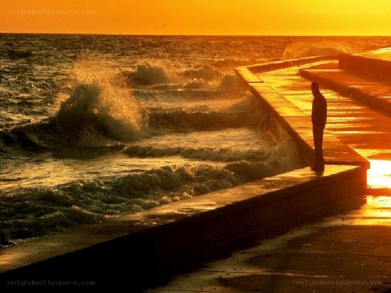 Person on pier at sunset