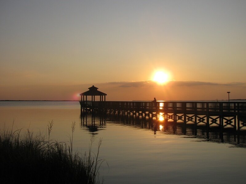 Person on Pier at Sunset — Orange