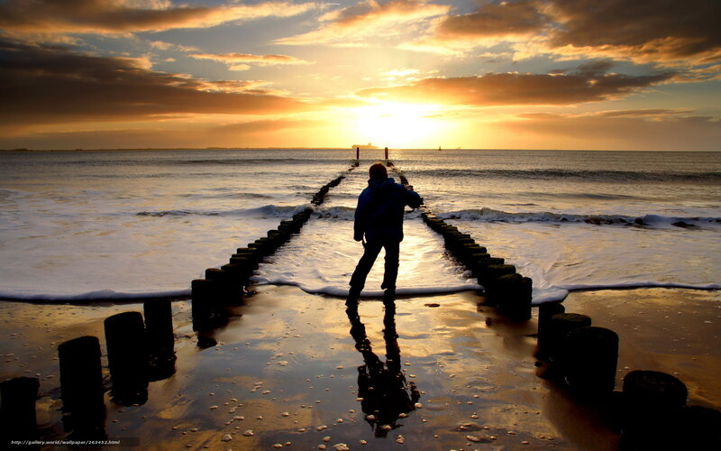 Person on pier at sunset
