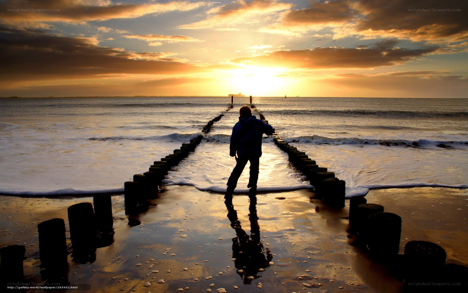 Person on pier at sunset