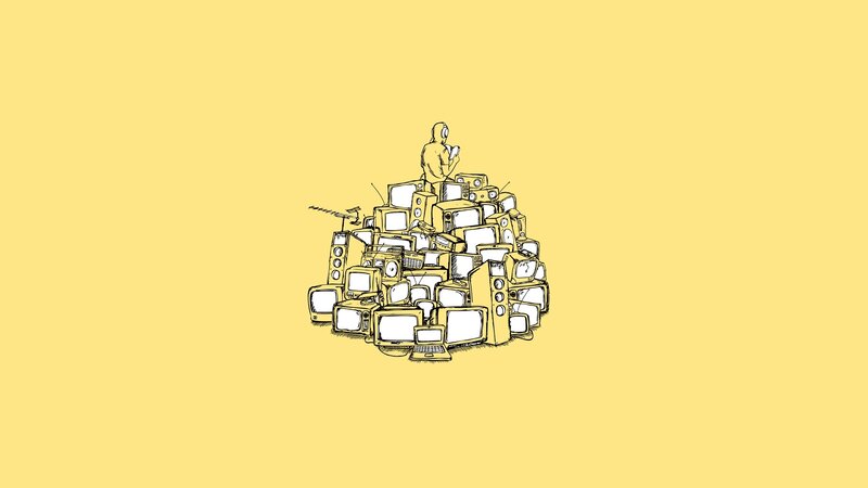 person on pile of electronics