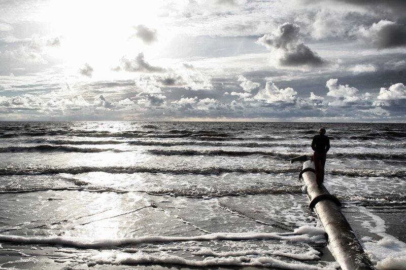Person on pipe at beach