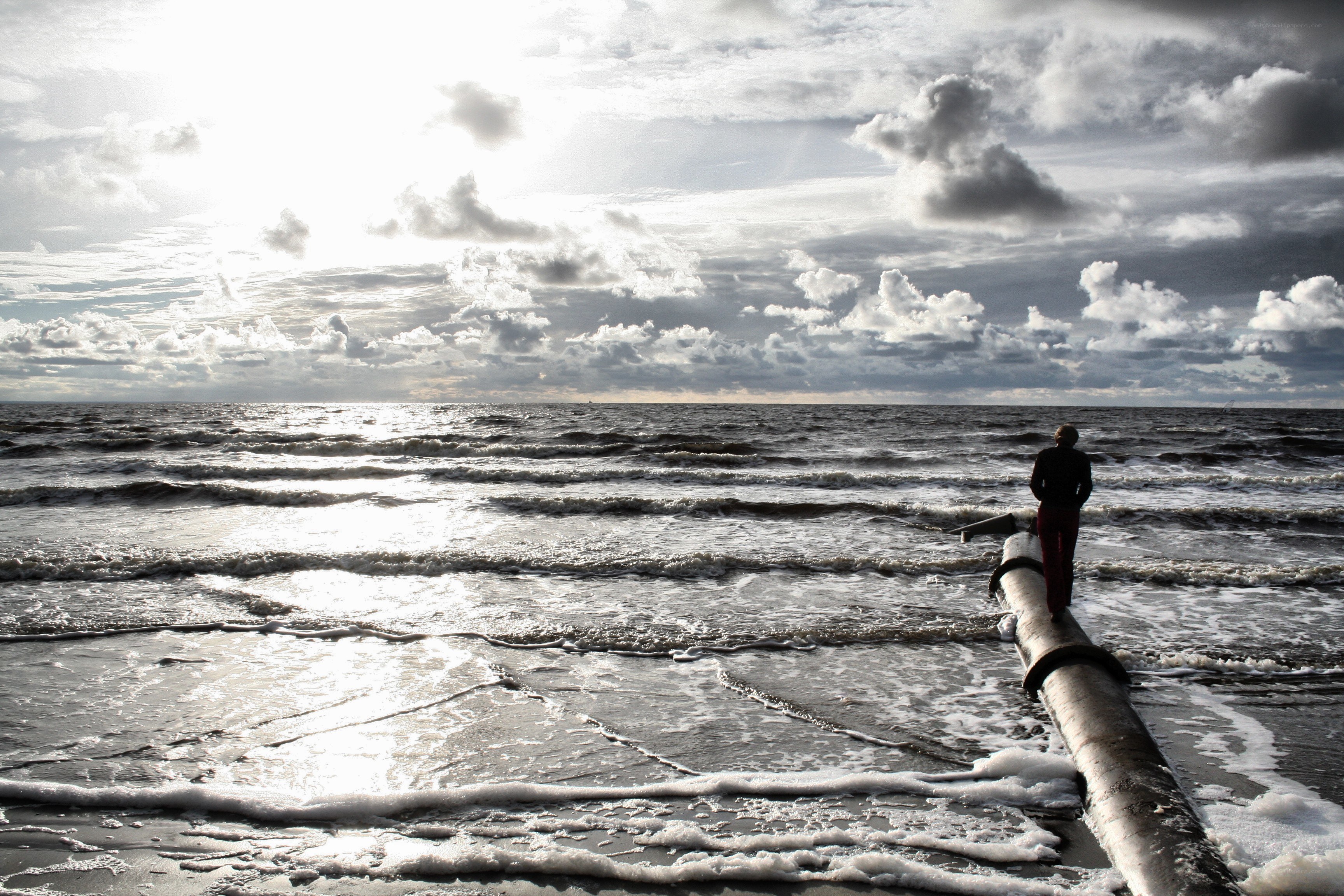Person on pipe at beach