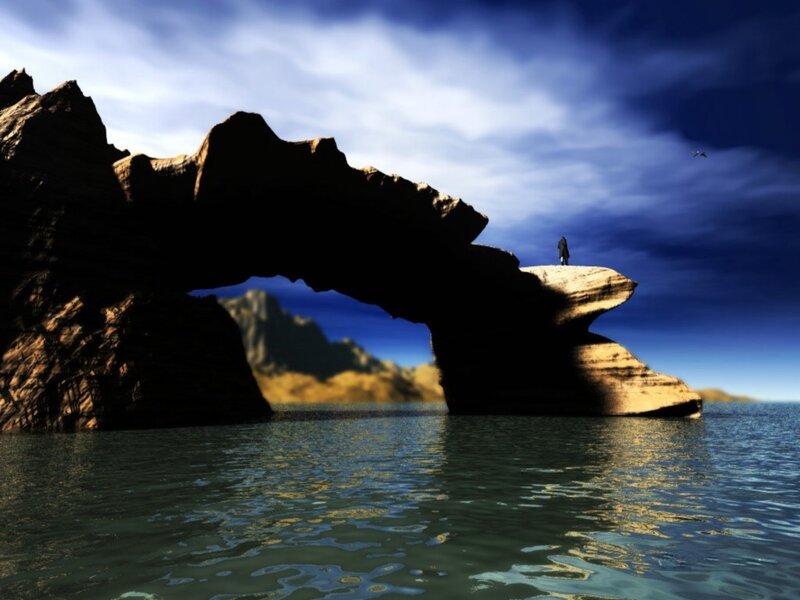 person on rock arch by sea