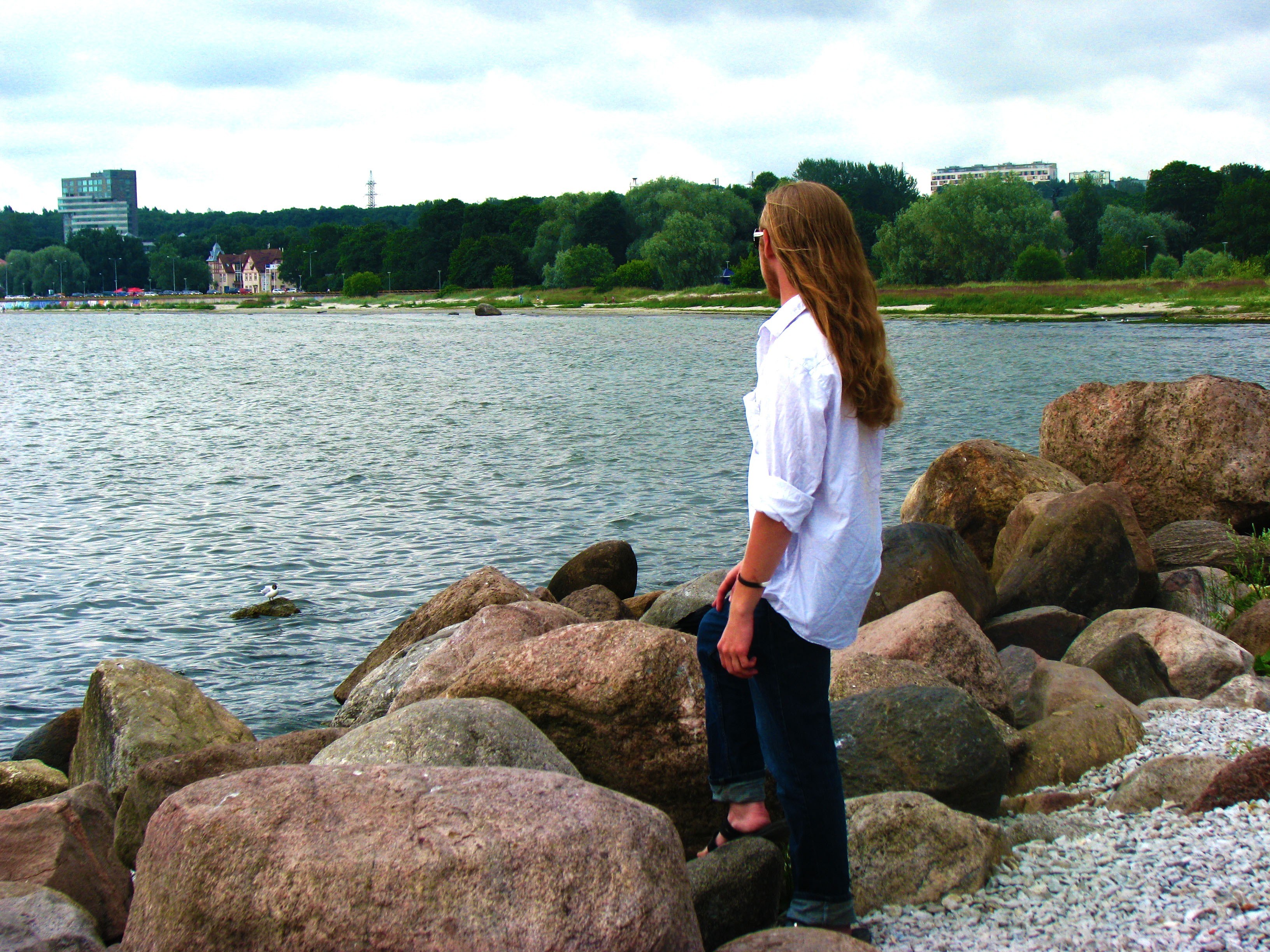 Person on rocks by water