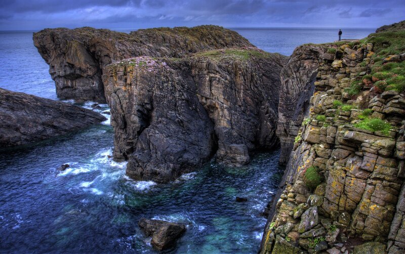 Person on Rocky Cliff — Blue