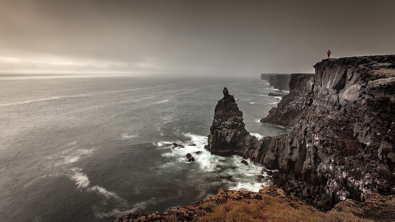 Person on Rocky Cliff — Gray, Dramatic