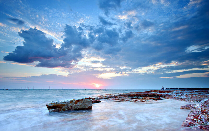 Person on Rocky Shore — Blue, Serene, Sunset, Photograph
