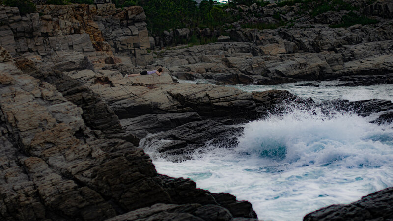 Person on Rocky Shore — Gray, Dramatic