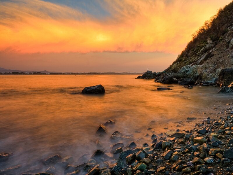 Person on Rocky Shore — Orange, Serene, Sunset