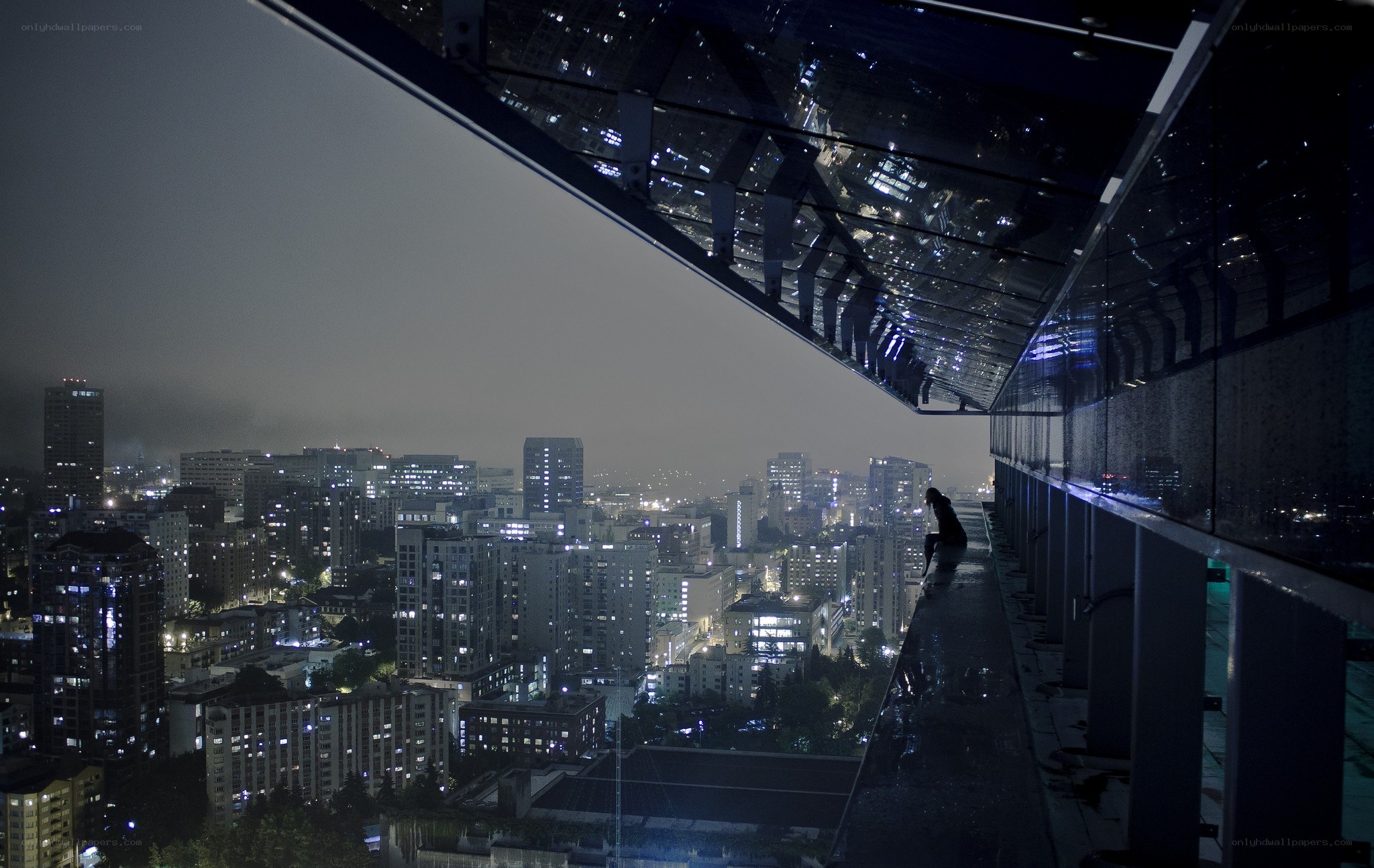 person on rooftop at night