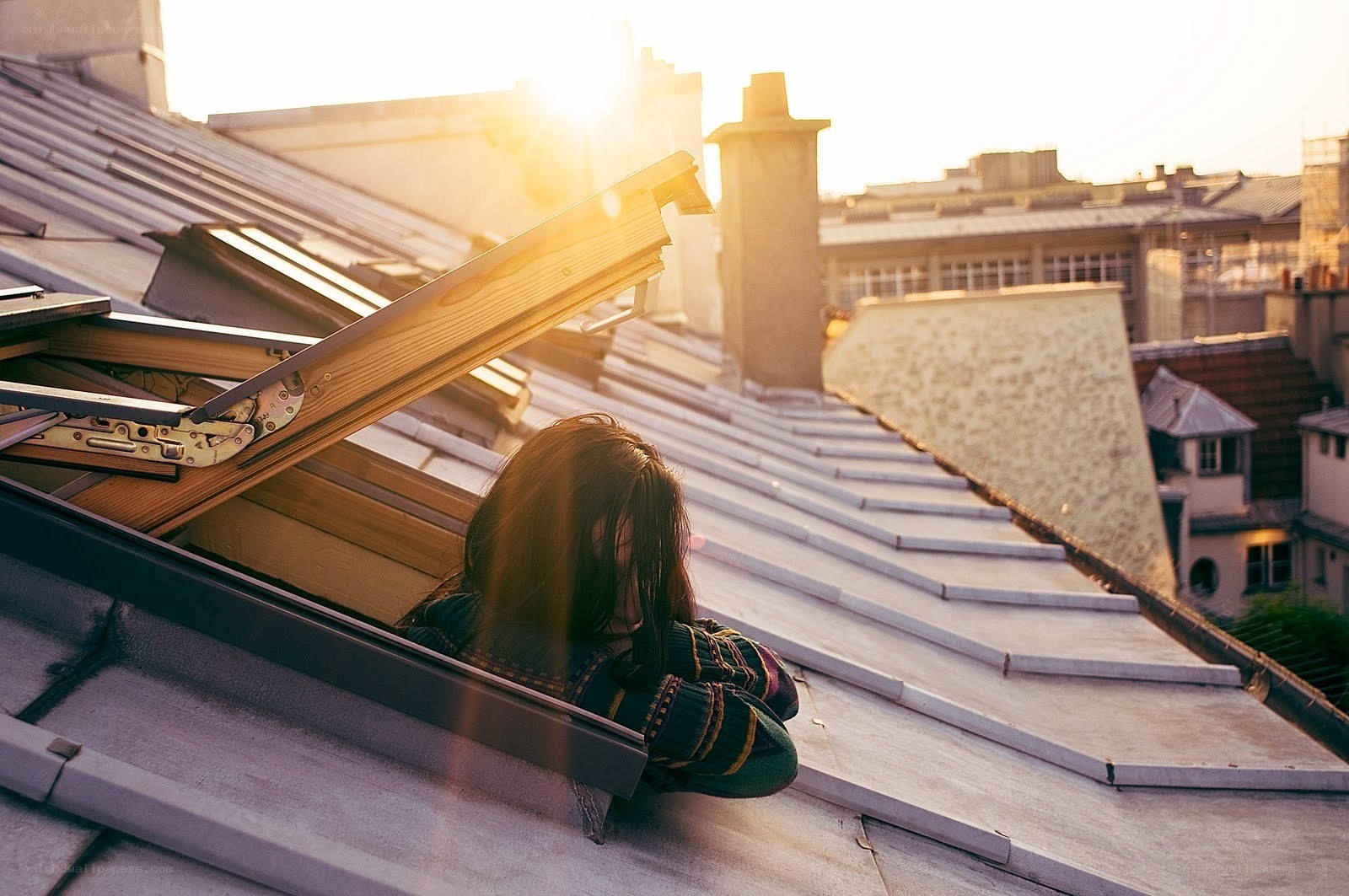 Person on rooftop at sunset