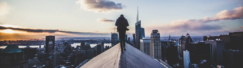 Person on Rooftop Edge — Blue, Dramatic
