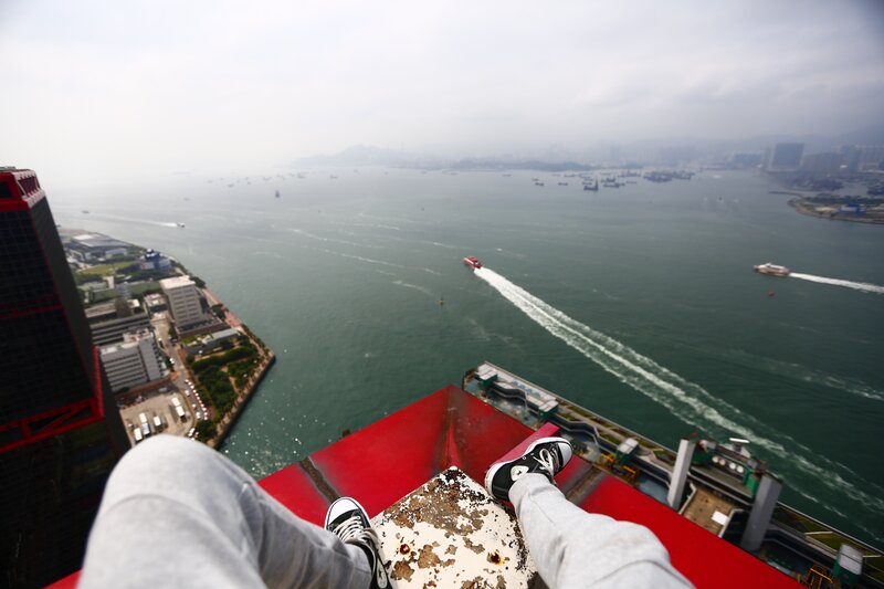 Person on Rooftop Edge — Red