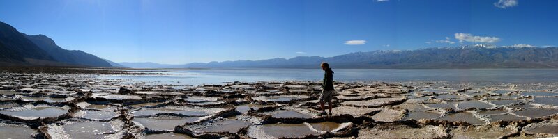 person on salt flats with mountains
