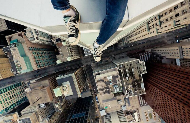 Person on Skyscraper Edge — Blue