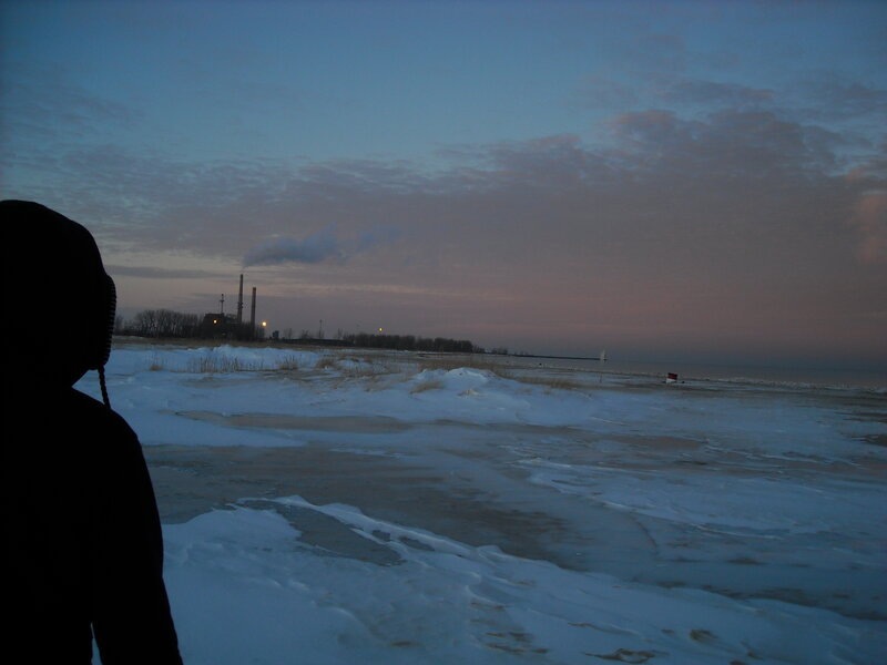 person on snowy beach at dusk