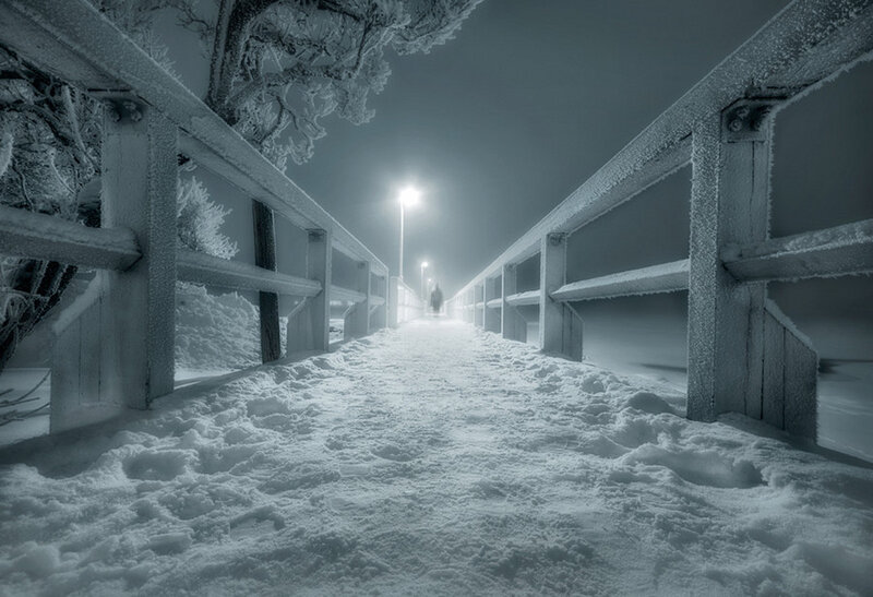 Person on Snowy Bridge