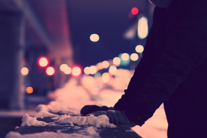 person on snowy street at night