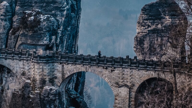 Person on Stone Bridge — Gray, Dramatic, Winter