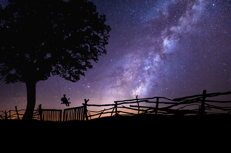 Person on Swing under Stars