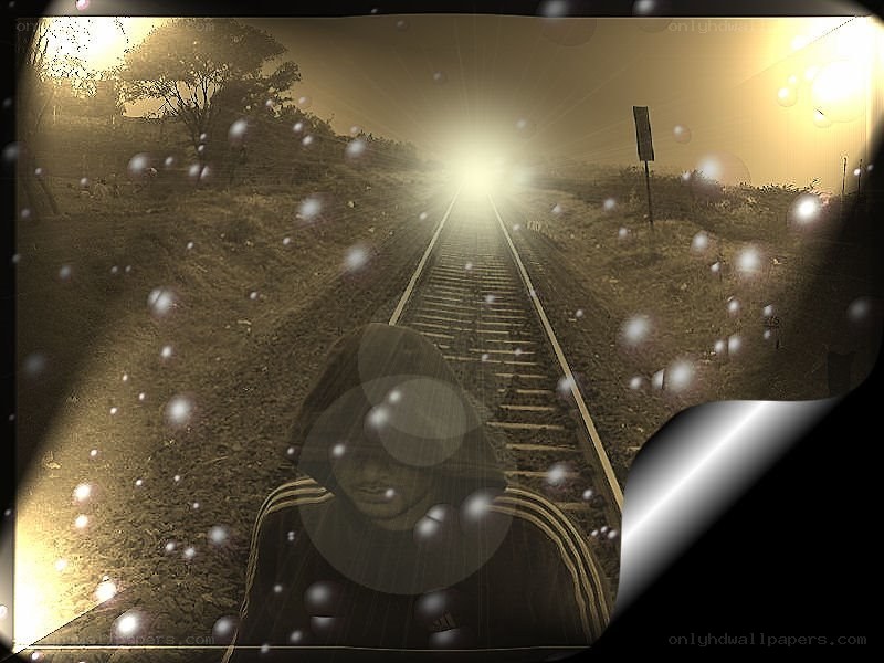 person on train tracks at sunset