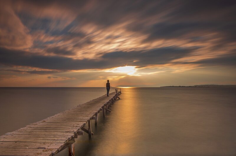 Person on Wooden Pier — Orange