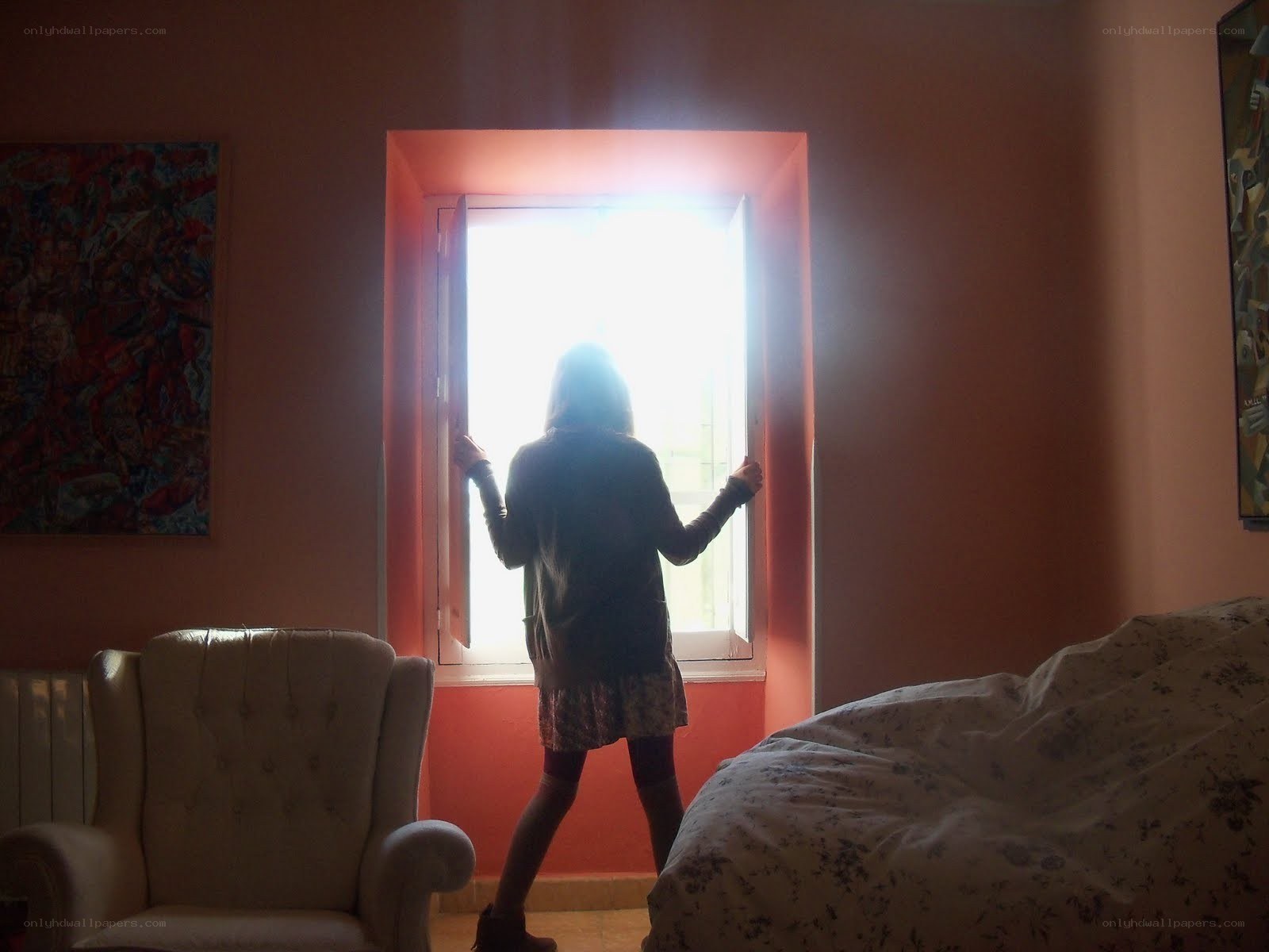 person opening window at sunrise