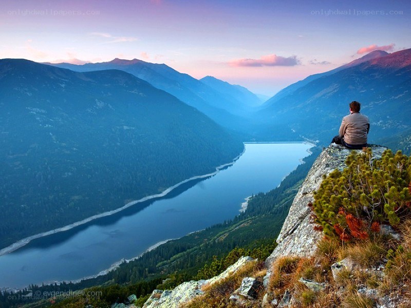 Person overlooking a mountain lake