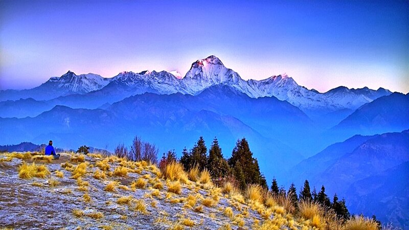 person overlooking snow-capped mountains