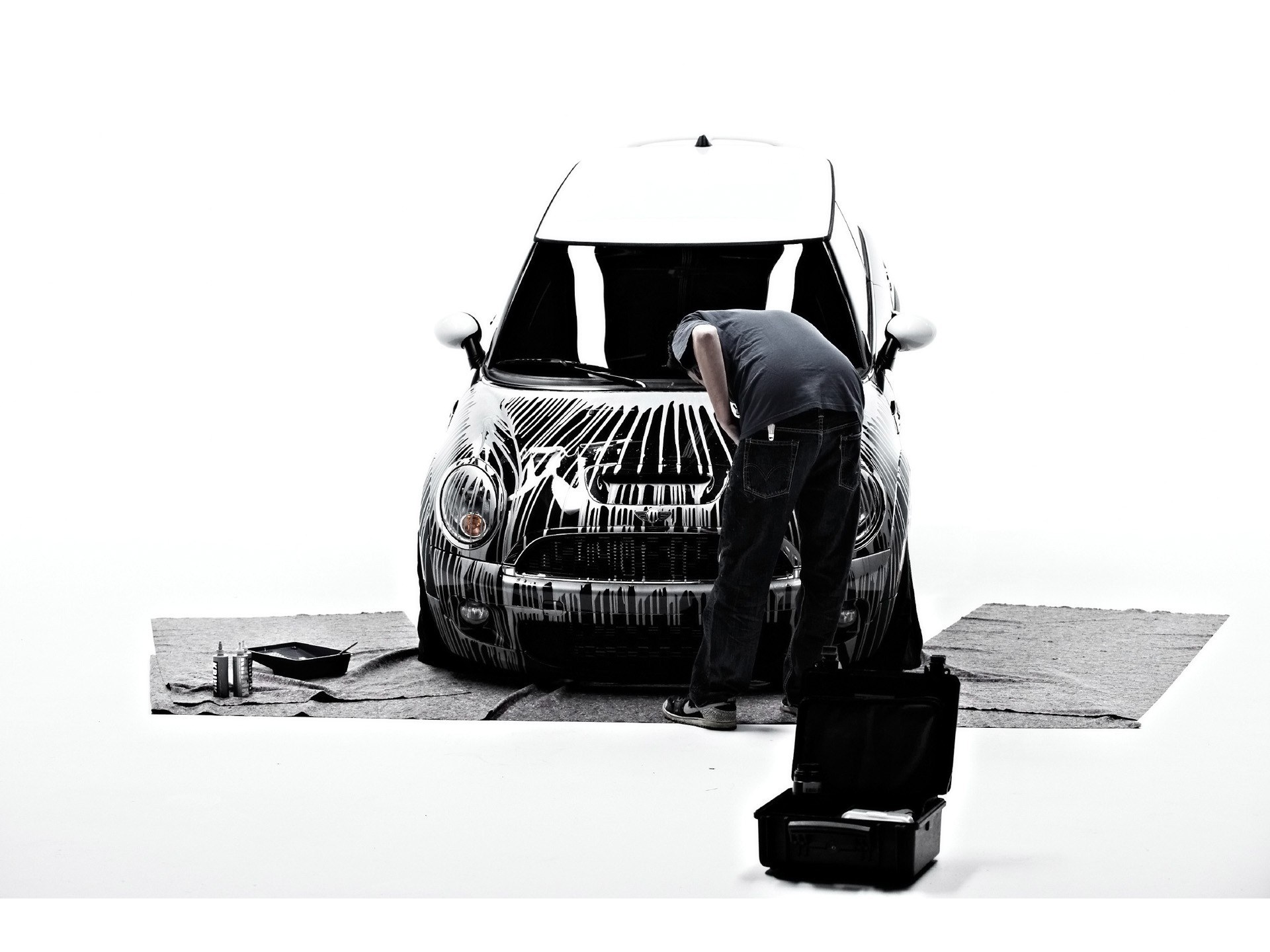 person painting a car