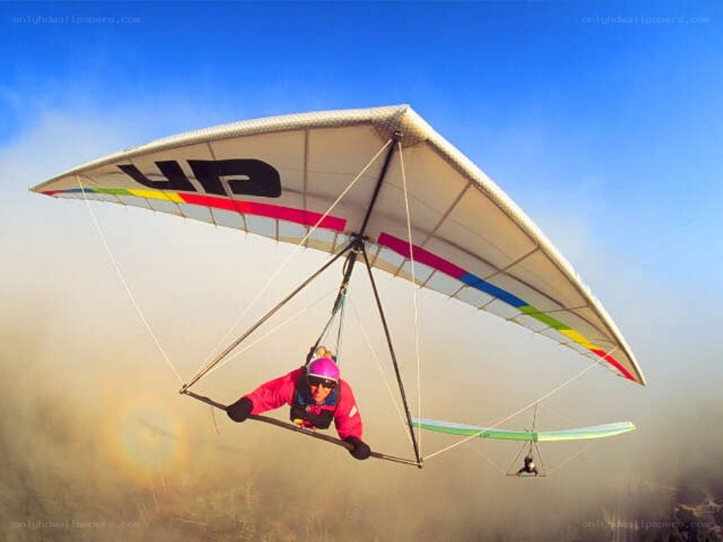 Person paragliding in the sky