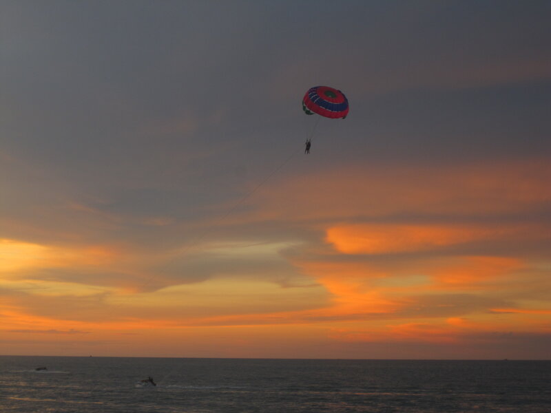Person Parasailing at Sunset