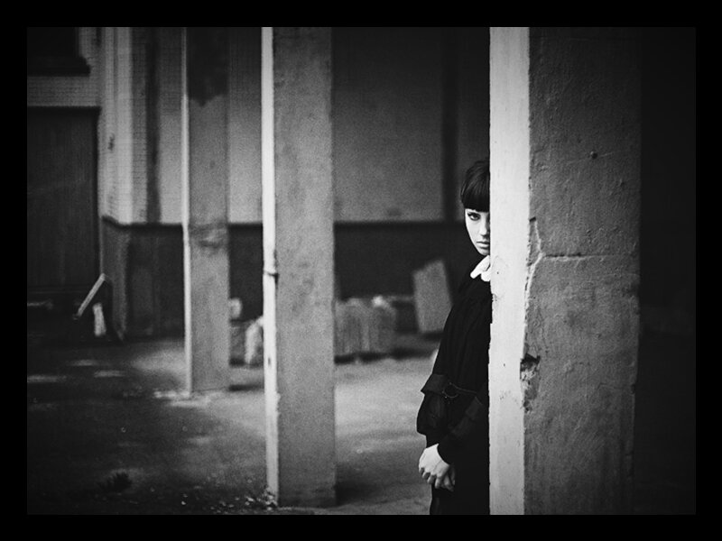 Person Peeking from Behind Pillar