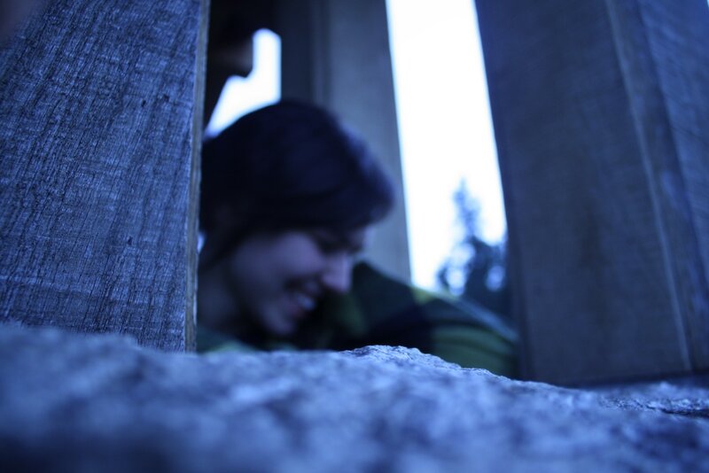 person peeking through wooden structure